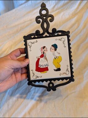2/40$ Vintage Black Cast Iron Trivet with Dutch Boy & Girl Tile